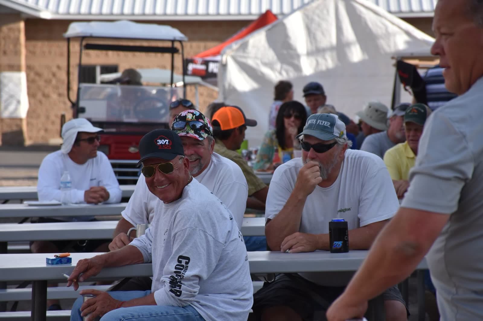 Members at the picnic tables outside the Lodge during a shoot.